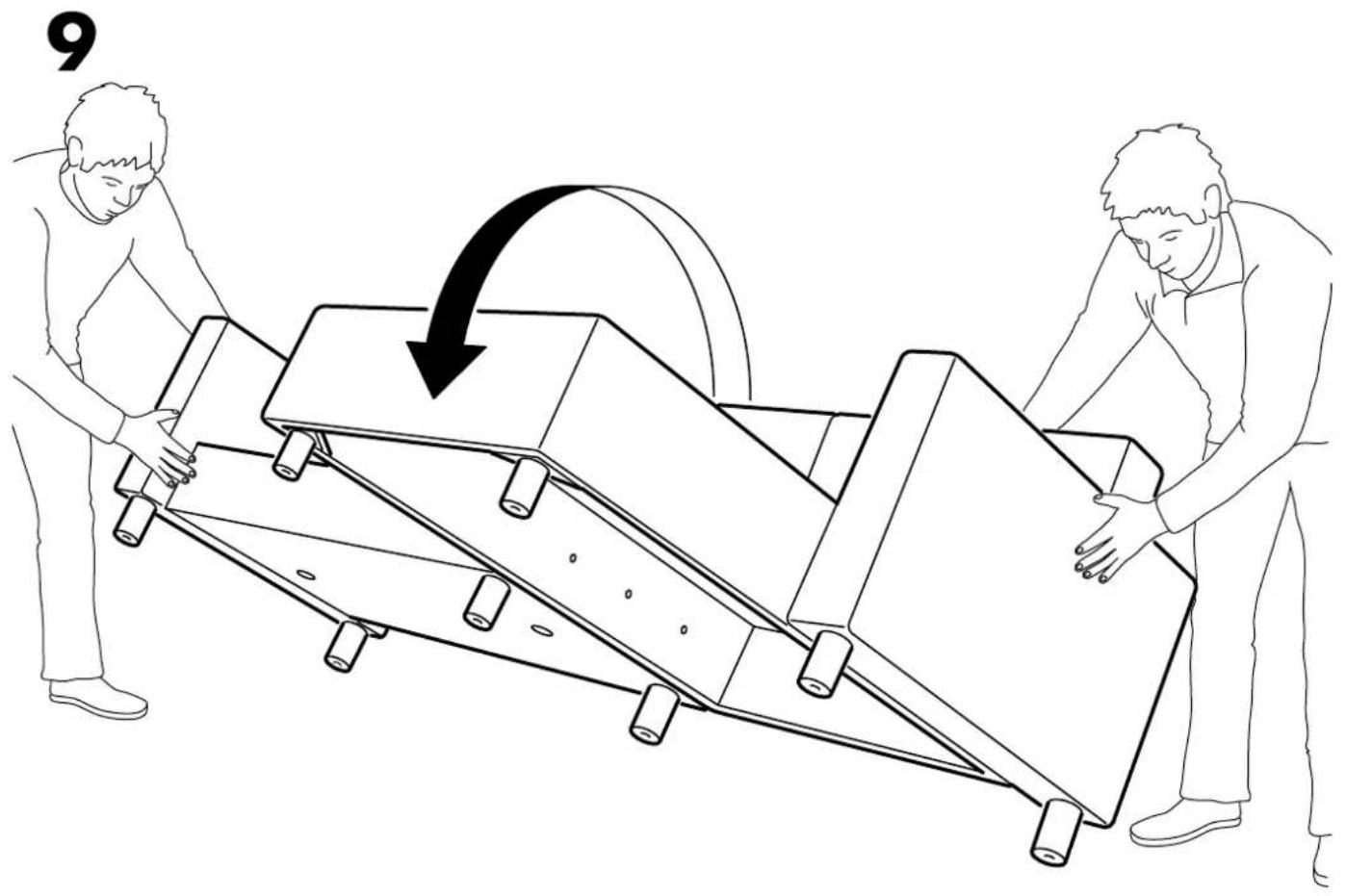 Line drawing of two people handling a large mechanical device with an arrow indicating motion (no text or symbols)