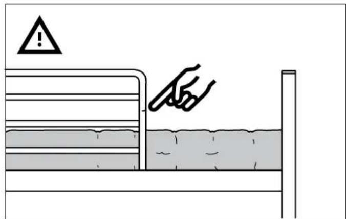 Safety warning illustration showing a hand pressing down on a bed with warning symbol above