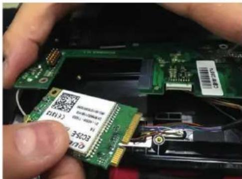 Close-up of hands installing a green PCI B2563 EMI chip into an electronic circuit board, with visible serial numbers and component labels.