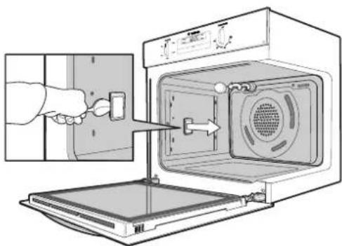 Diagram showing a hand inserting a switch into an oven with a door panel, illustrating appliance ventilation or cleaning process.