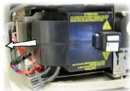 Close-up of an electronic device with warning labels and a warning label, showing electrical components and wiring.