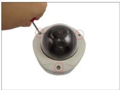Close-up of a hand using a screwdriver to adjust a spherical security camera (no text or symbols visible)