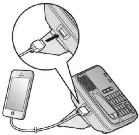 Diagram showing a smartphone connected to a landline telephone via cable, with an arrow indicating the cable being inserted into the device.
