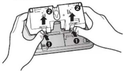Diagram showing two hands holding a device with labeled parts and directional arrows indicating movement or assembly.
