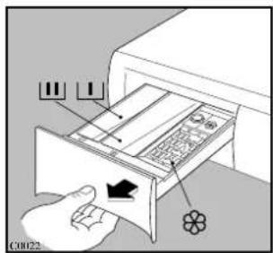 Diagram showing a hand inserting a device into a drawer with labeled parts and an arrow indicating direction.