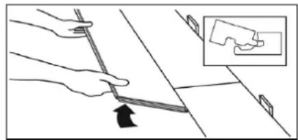 Illustration of a hand holding a tool with an arrow indicating direction, next to a magnified inset showing a hand holding a small object (no text or symbols present)