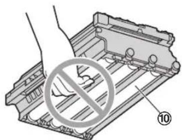 Diagram showing a hand holding a device with a prohibition symbol and numbered label 10