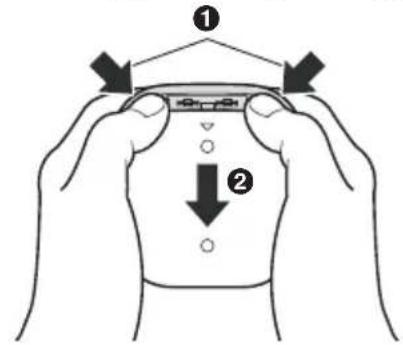 Diagram showing two hands holding a device with labeled parts, indicating assembly or positioning steps.