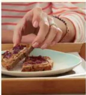 Close-up of hands preparing food with a slice of purple topping on a white plate (no text or symbols visible)