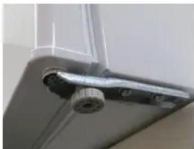 Close-up of a metallic mechanical component mounted on a ceiling, no visible text or symbols