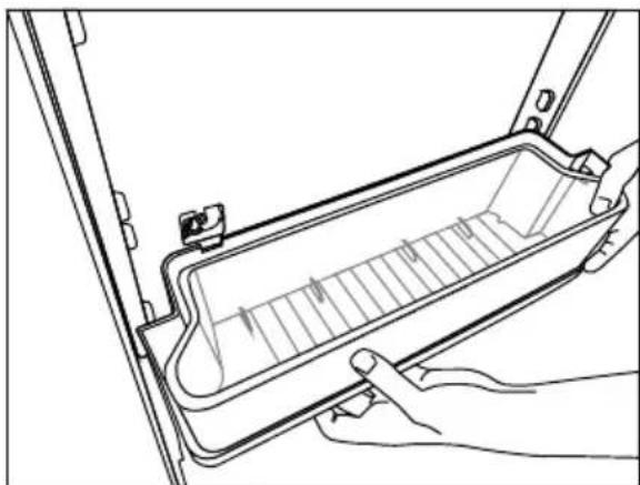 Line drawing of a hand inserting a plastic tray into a container, no text or symbols.