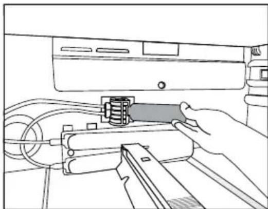 Line drawing of a hand inserting a component into a device (no text or symbols).