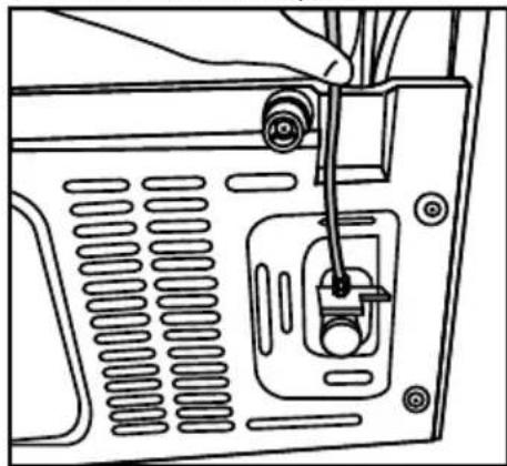 Line drawing of a device rear panel with a hand inserted, showing internal components and wiring (no text or symbols)