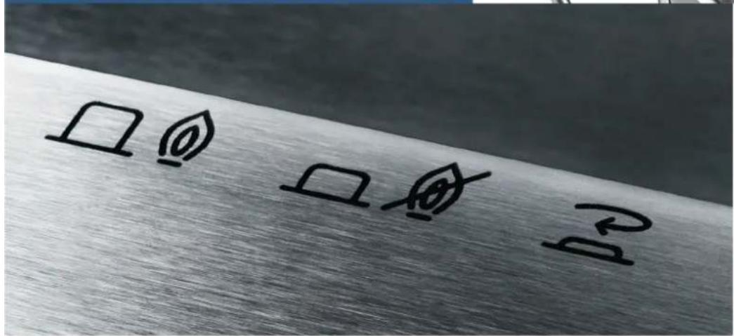 Handwritten symbols including a leaf, a flame, and a question mark on a metallic surface