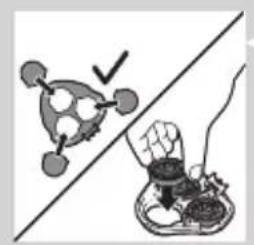 Simple line drawing of a hand holding a small object above a bowl, with a checkmark and arrow indicating inspection or verification (no text or symbols)