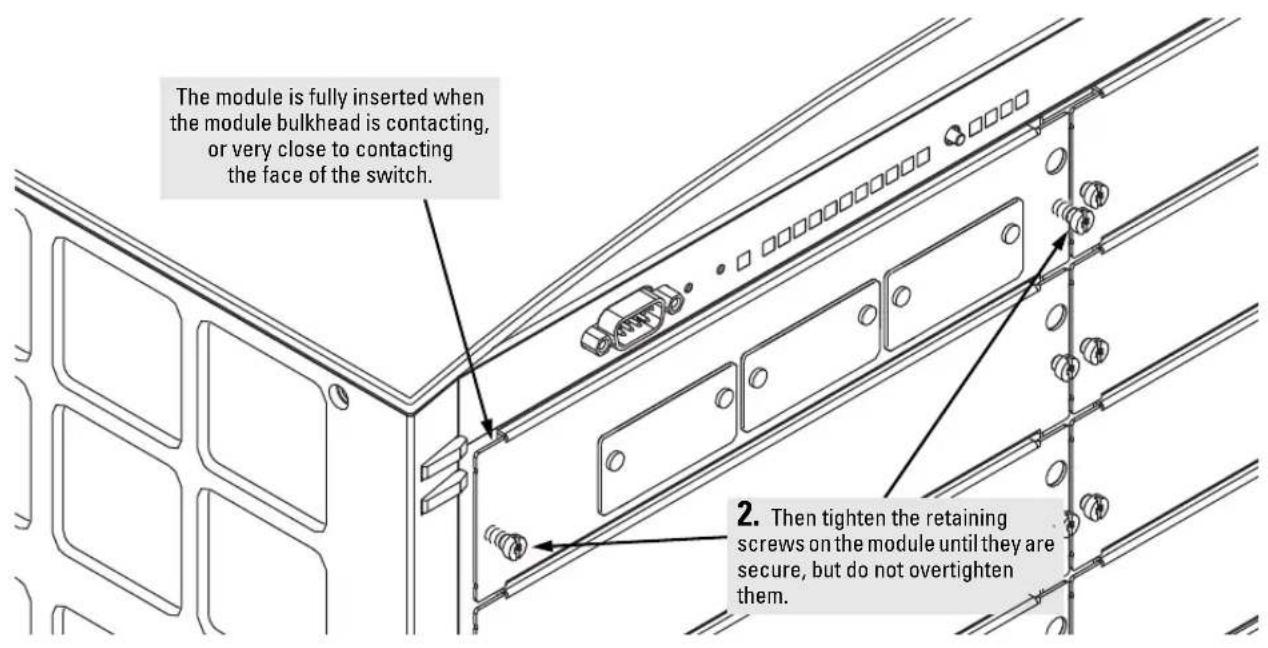 The module is fully inserted when the module bulkhead is contacting, or very close to contacting the face of the switch. 2. Then tighten the retaining screws on the module until they are secure, but do not overtighten them.