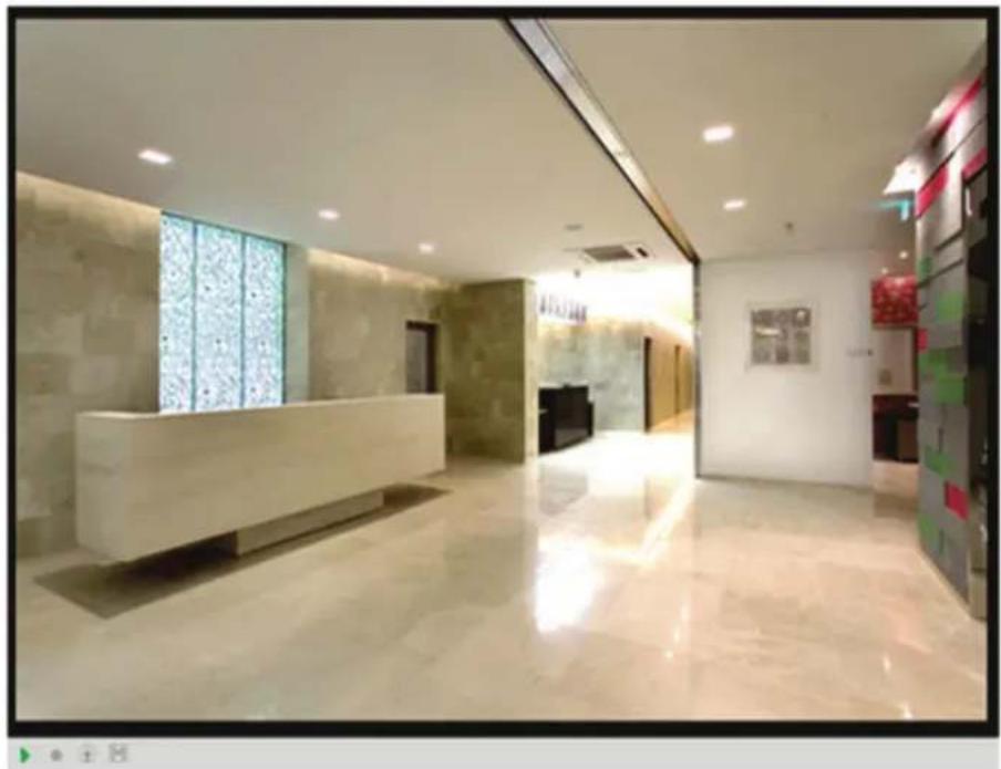 Interior view of a modern hotel lobby with marble flooring, reception desk, and glass partition (no visible text or signage)