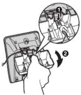 Diagram showing hand inserting a component into a device with an inset close-up highlighting a mechanical component detail.