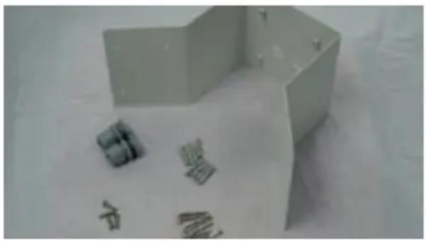White paper cutout with handwritten Chinese characters on paper, likely a diagram or instruction sheet