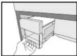 Simple line drawing of a hand inserting a component into a wall (no text or symbols).