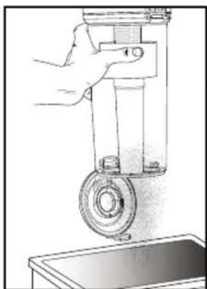 Illustration of a hand holding a cylindrical mechanical component with a circular base, next to a small bowl (no text or symbols)