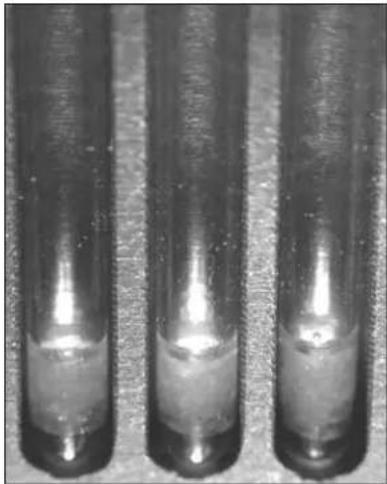 Three identical cylindrical objects with metallic surfaces, no visible text or symbols