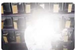 Interior view of a storage room with shelves and a bright light source (no visible text or symbols)