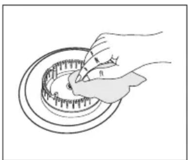 Illustration of a hand turning a circular mechanical component with teeth (no text or symbols)