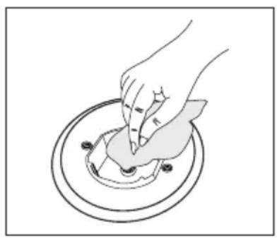 Illustration of a hand pressing down on a circular object with a small object inside (no text or symbols)