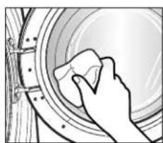 Hand washing a large circular object with a cloth (no text or symbols visible)