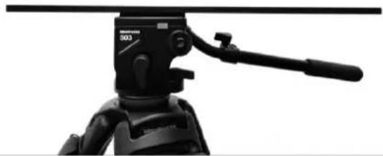 Close-up of a black tripod-mounted camera with a lever handle (no visible text or symbols)