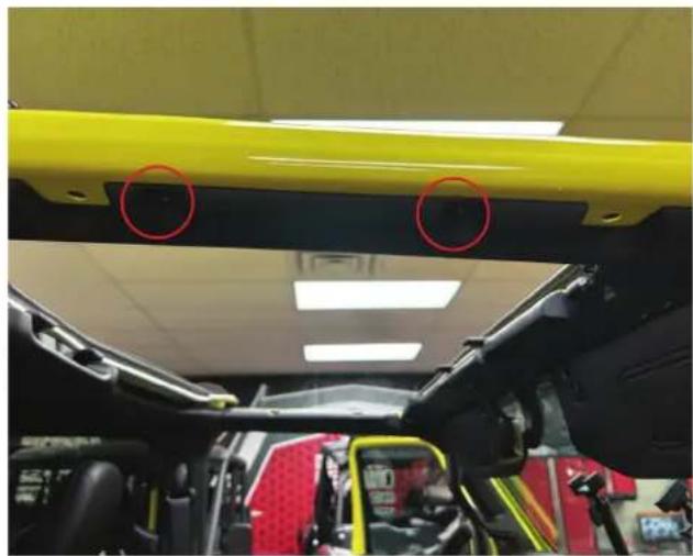 Interior view of a vehicle showing a yellow overhead structure with two red-circled annotations, no visible text or symbols.