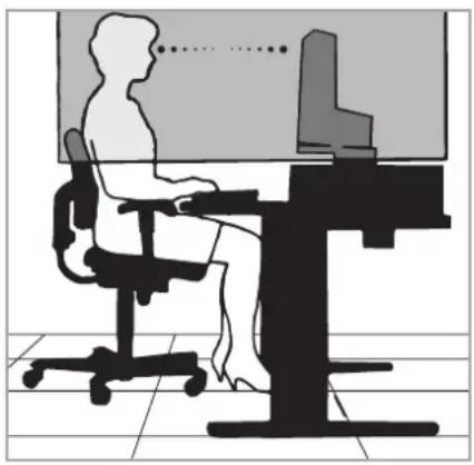 Silhouette of a person sitting at a desk with a computer, viewed from the side (no text or symbols present)