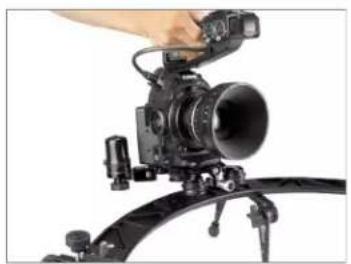 Close-up of a camera setup with a mounted lens and tripod mount (no visible text or symbols)