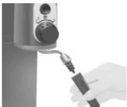 Close-up of a hand holding a small object with a tool, next to a mounted device (no visible text or symbols)
