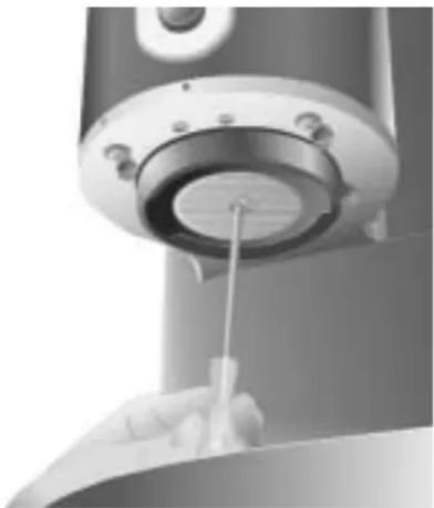 Close-up of a kitchen brush applying liquid to a surface, no visible text or symbols