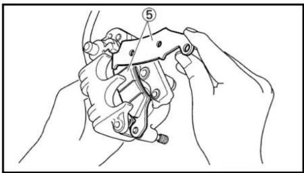 Technical diagram showing hands operating a mechanical clamp or bracket with numbered annotation (5) indicating a specific component.