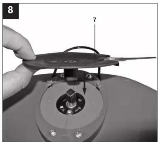 Close-up of a hand holding a small electronic device with a labeled component (7).