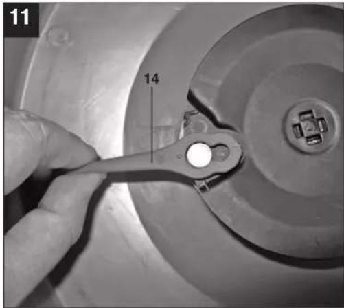 Close-up of a hand using a wrench to adjust a mechanical component.