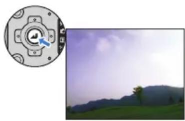 Composite image showing a circular emblem with a central knob and a landscape photo of a hill under a cloudy sky (no text or symbols)