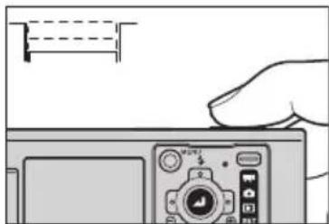 Illustration of a hand pressing down on a digital camera module (no text or symbols visible)