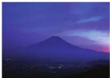 Mountain silhouette at dusk with purple and pink sky, no visible text or symbols