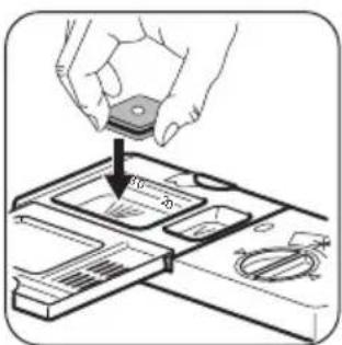 Diagram showing a hand placing a component into a device with labeled parts and directional arrows