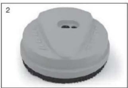 Close-up of a white plastic soap dispenser with a circular cap and textured base (no text or symbols visible).
