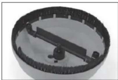 Close-up of a mechanical component with a circular base and central lever (no visible text or symbols)