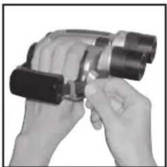 Close-up of hands holding a handheld device with black buttons (no visible text or symbols)