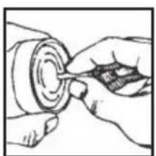 Illustration of hands using a tool to adjust or install a circular component (no text or symbols visible)