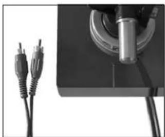 Close-up of a mechanical device with two connected cables and a cylindrical component (no visible text or symbols)