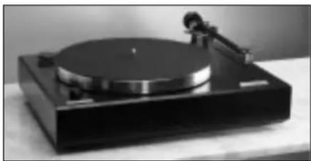 Black-and-white photo of a vintage typewriter with a circular top and mechanical knob (no visible text or symbols)