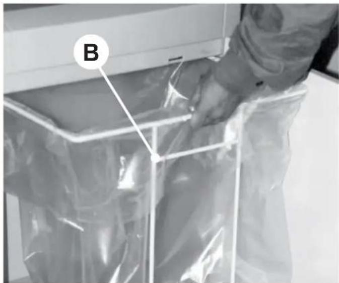 Person handling a transparent plastic bag labeled 'B' (no text or symbols on bag)